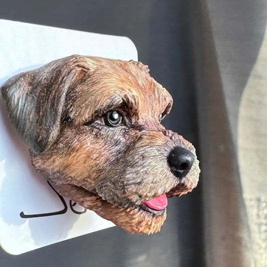 Hand-painted resin brooch of a grizzle Border Terrier with UV protection package display