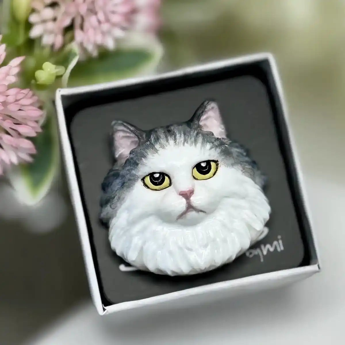 Ragdoll cat brooch with blue and white fur and grumpy eyes