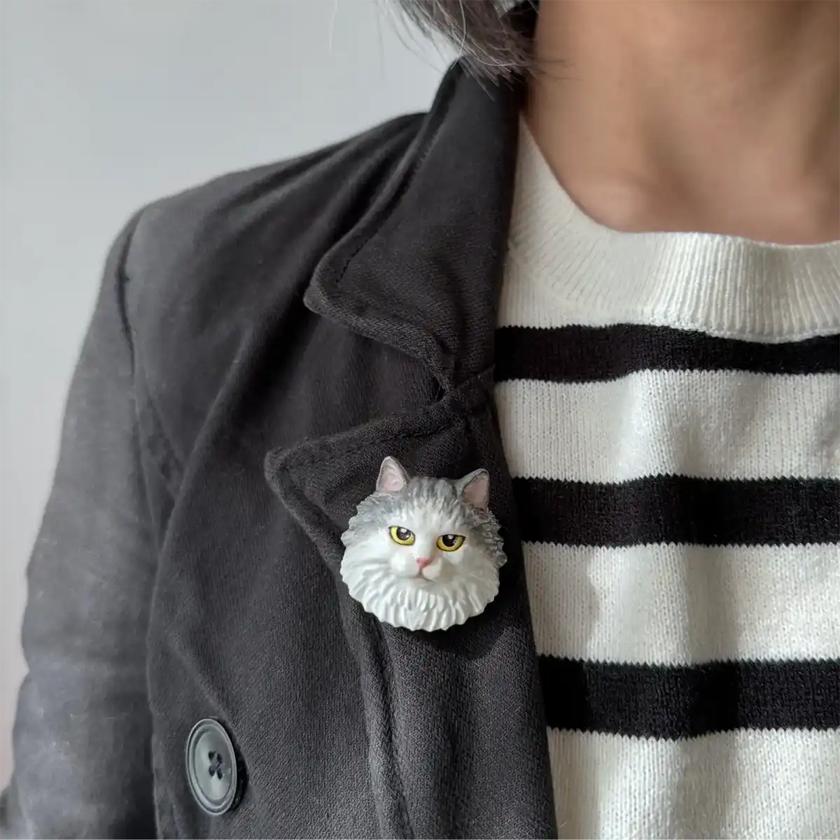 Ragdoll cat brooch with blue and white fur and grumpy eyes