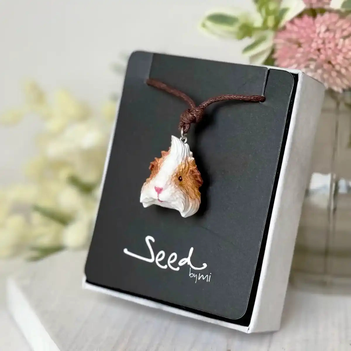 Hand-painted resin pendant of orange & white Abyssinian guinea pig on cotton cord