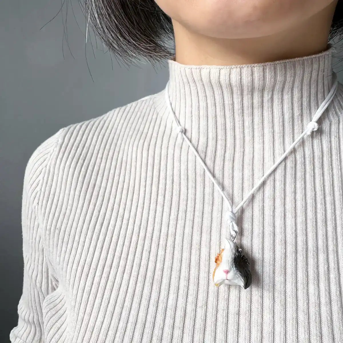 Lifelike tri-colour Abyssinian guinea pig pendant necklace on adjustable cord wearing