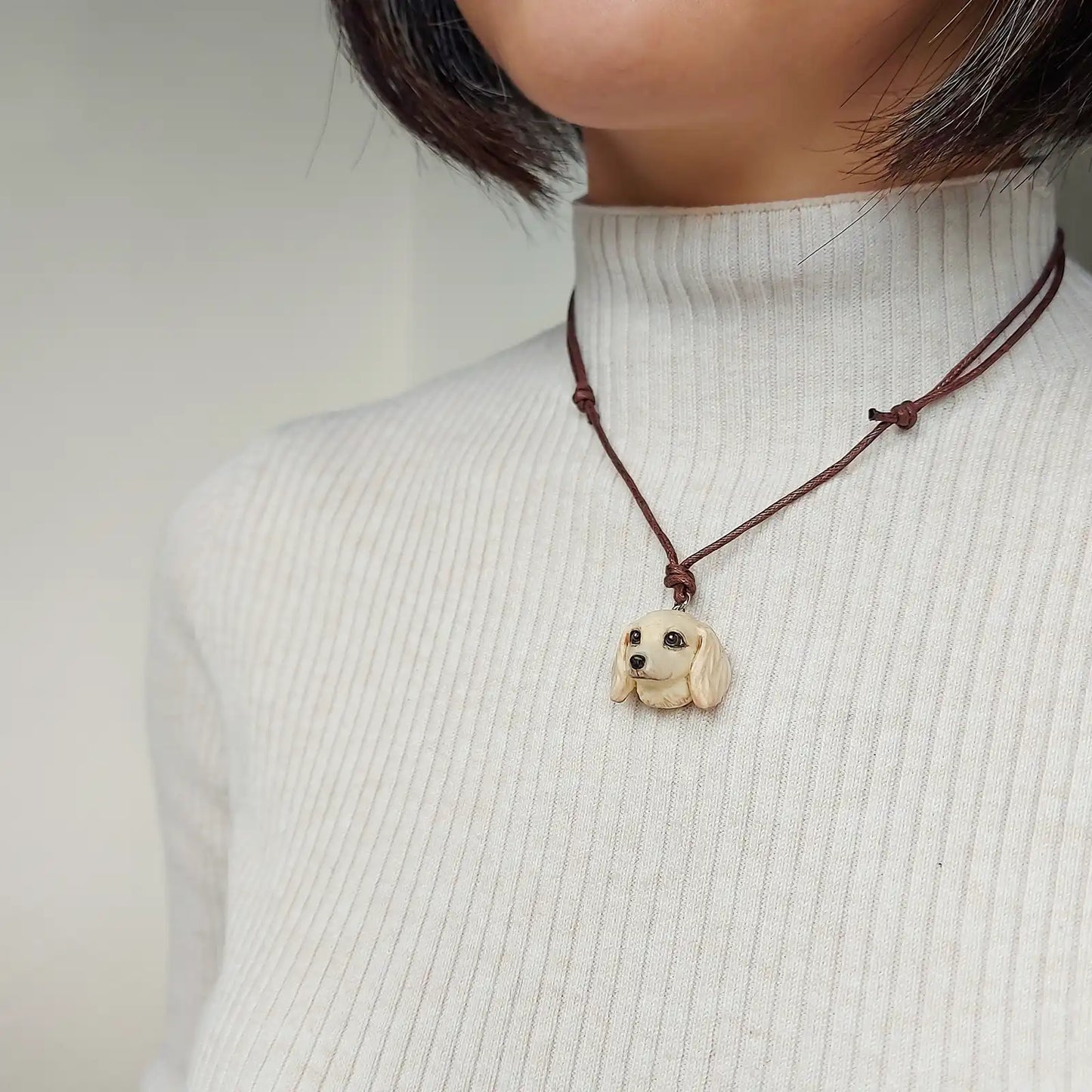 Cream Dachshund sausage pendant necklace with hand-painted resin finish wearing