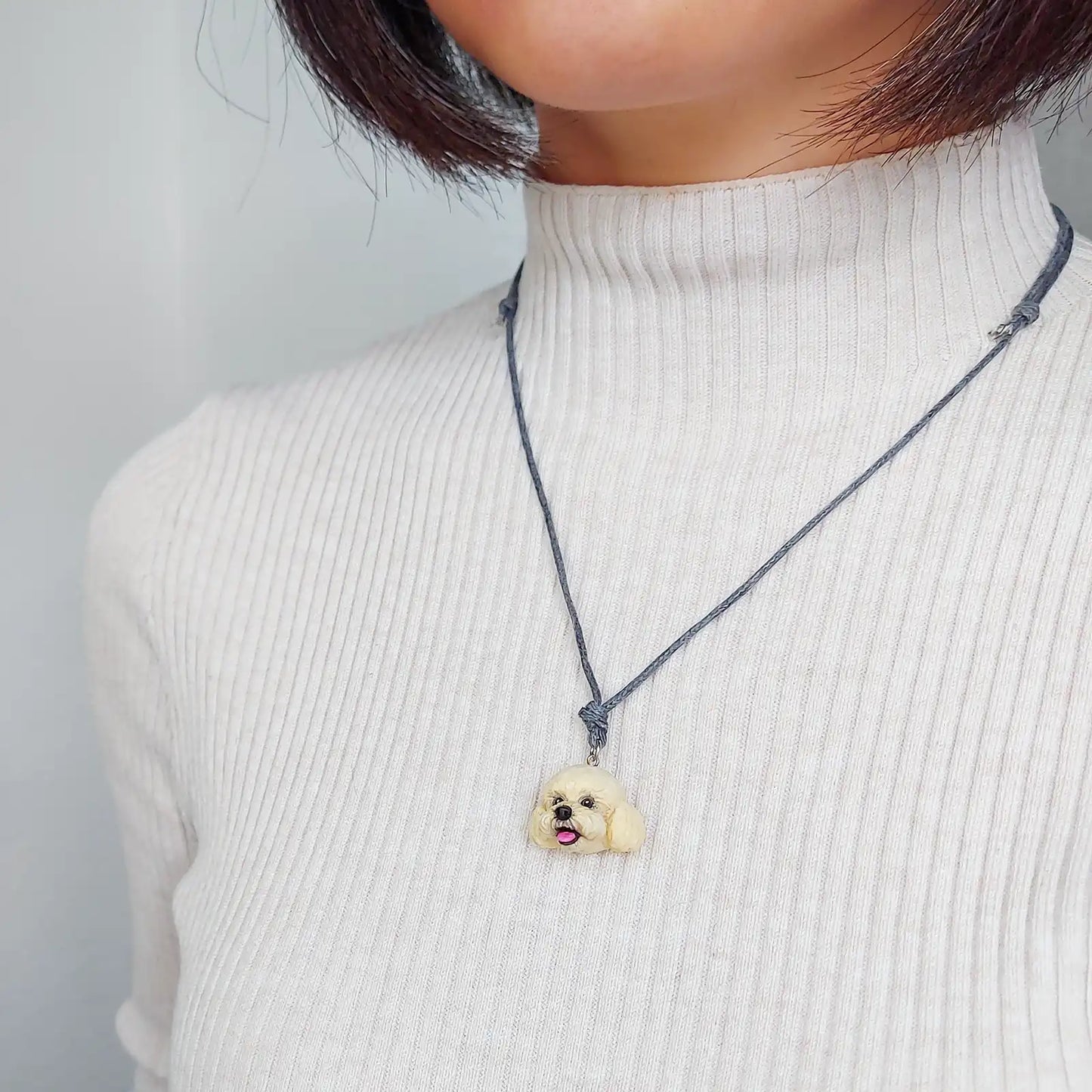 dog poodle cream pendant wearing