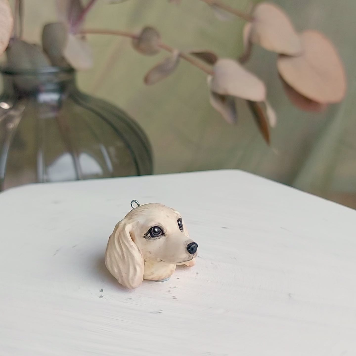 Cream Dachshund sausage pendant necklace with hand-painted resin finish turn table